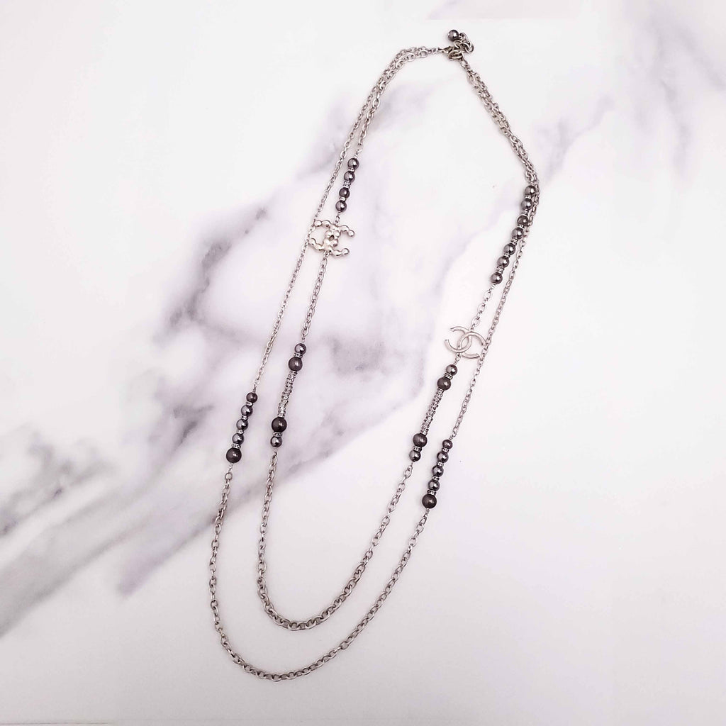 CHANEL GOLD, BRONZE, AND GREY LAYERED PEARL NECKLACE WITH CRYSTAL LOGOS