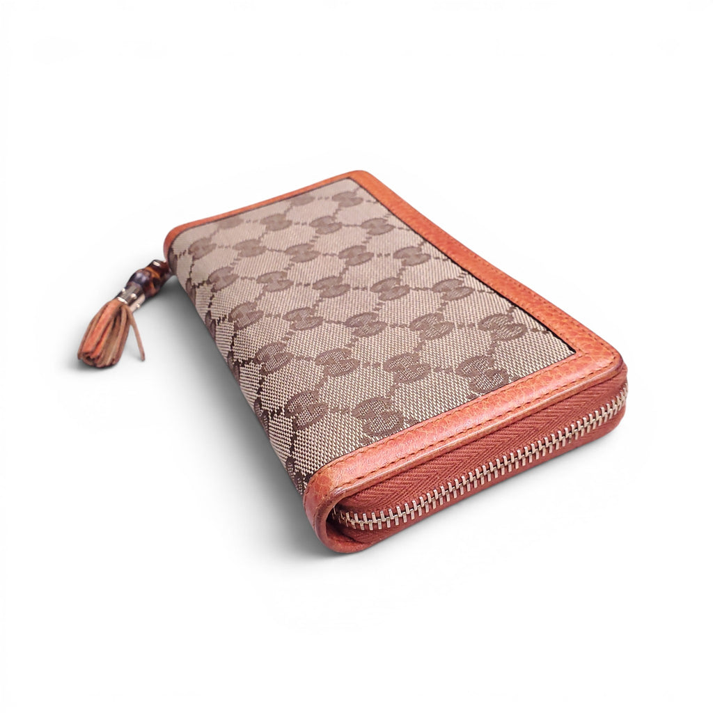 GUCCI MONOGRAM ZIP AROUND WALLET WITH BAMBOO TASSEL DETAIL