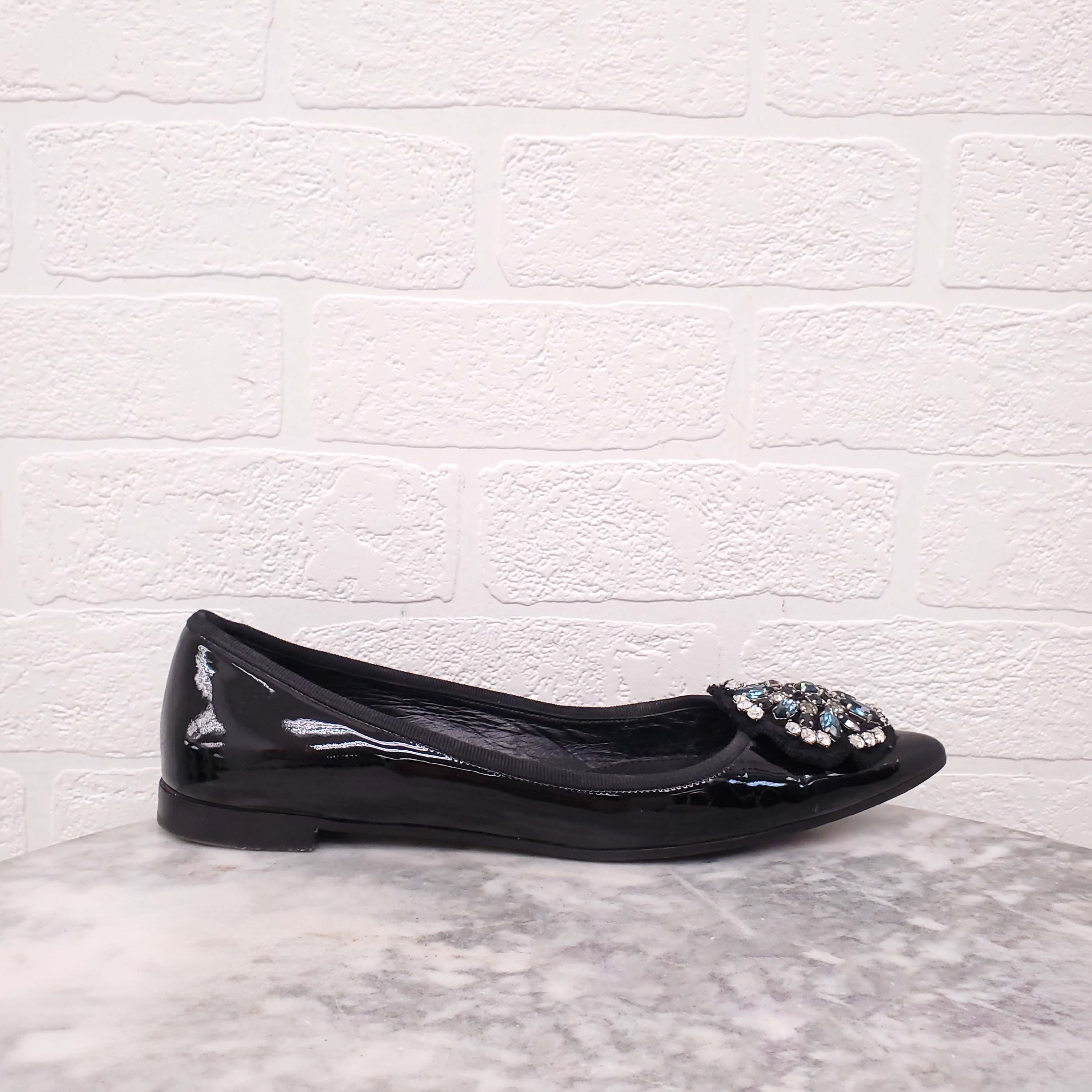 PRADA BLACK PATENT FLATS WITH CRYSTAL EMBLEM - SIZE 38.5