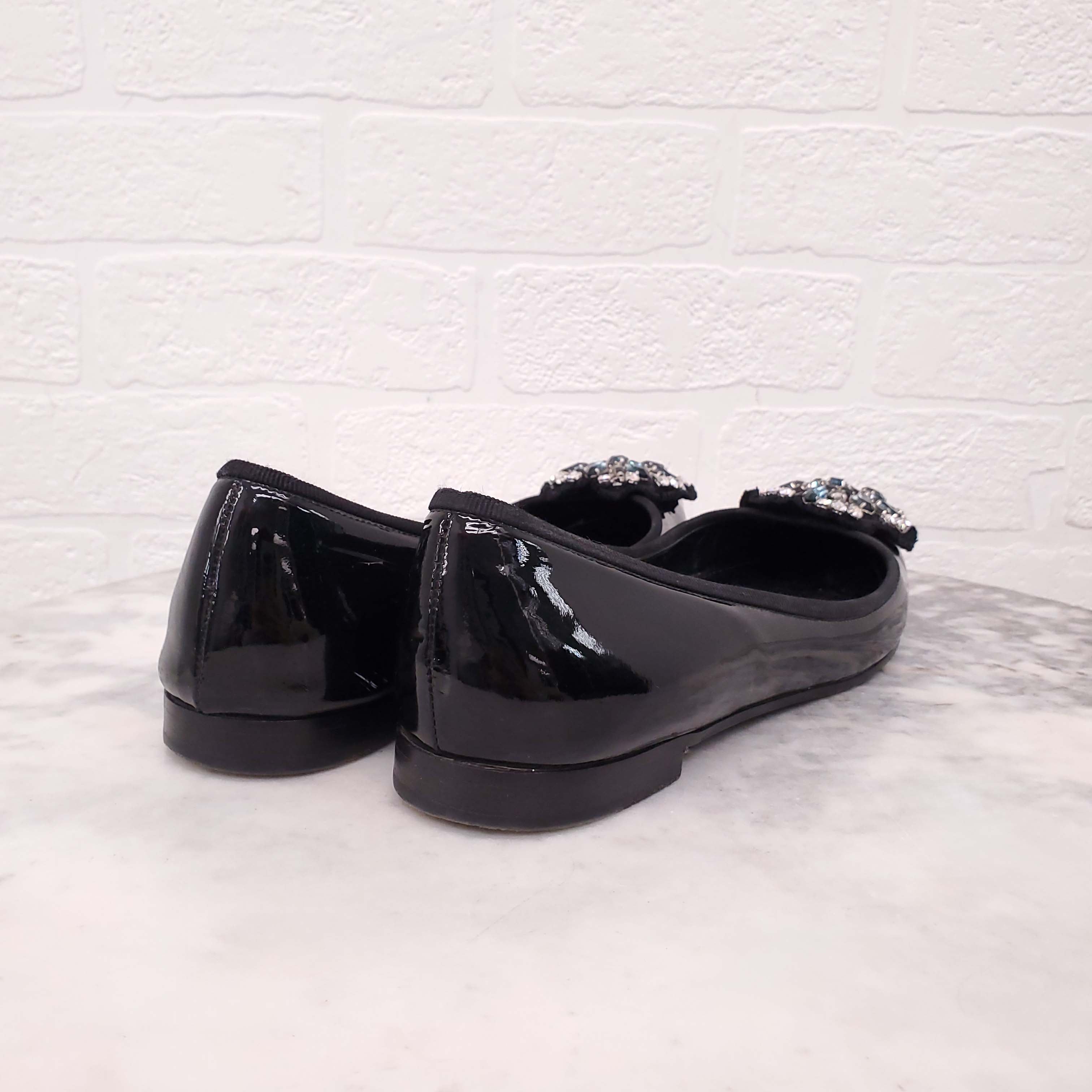 PRADA BLACK PATENT FLATS WITH CRYSTAL EMBLEM - SIZE 38.5