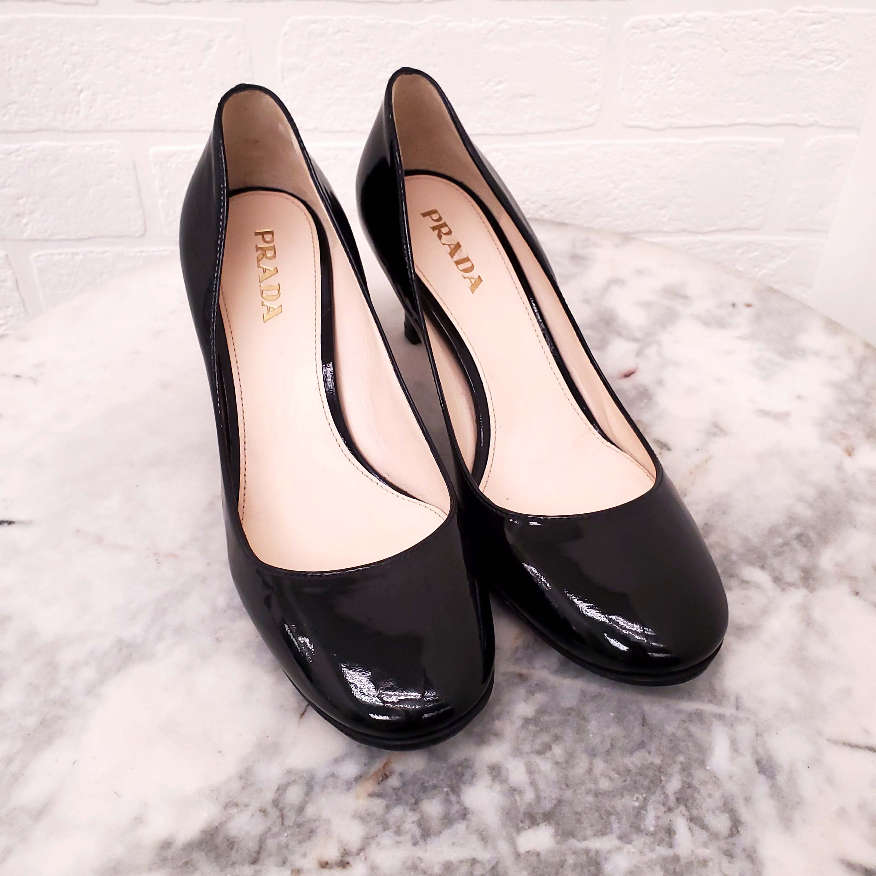 PRADA BLACK PATENT WITH GOLD LOGO HEELS - SIZE 36