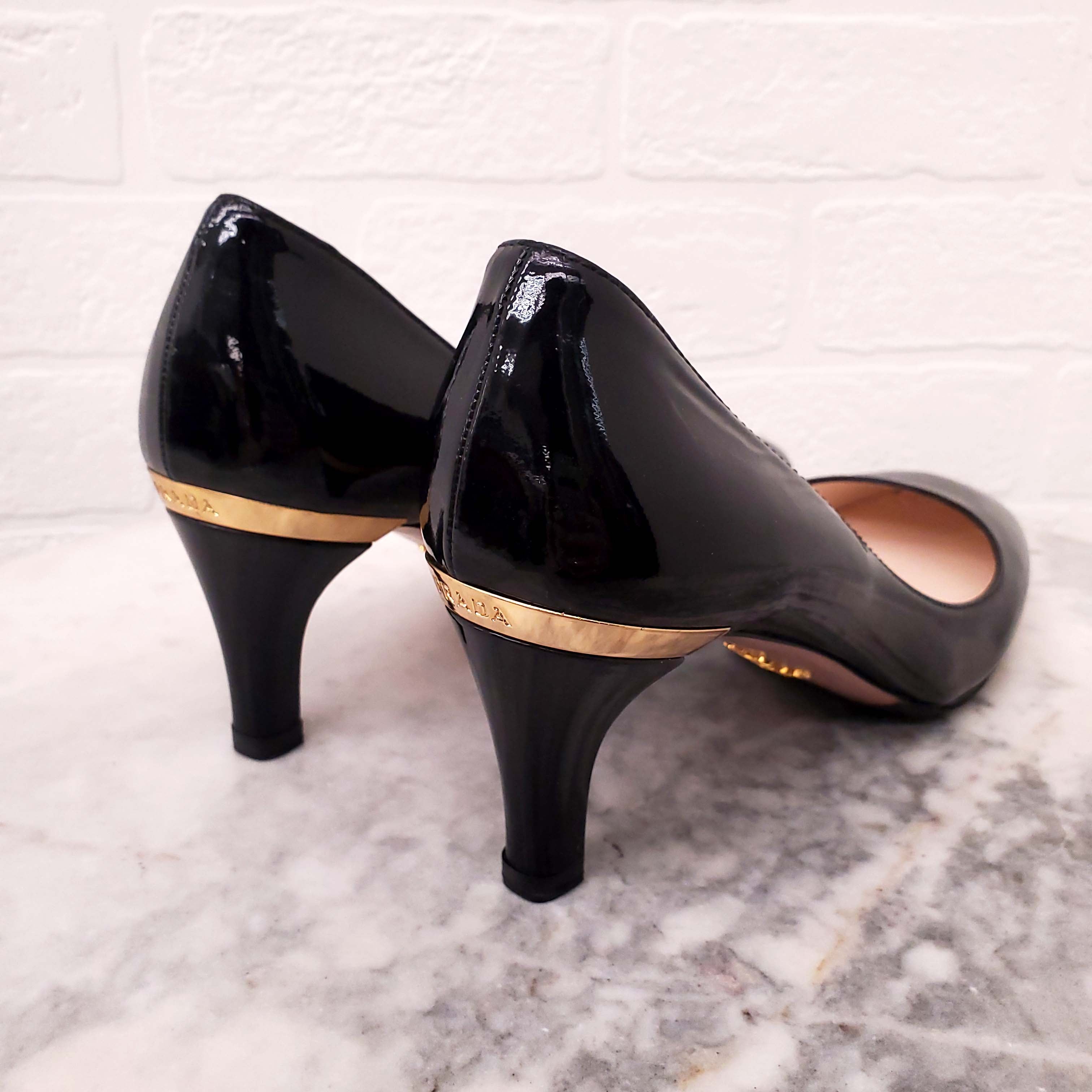 PRADA BLACK PATENT WITH GOLD LOGO HEELS - SIZE 36