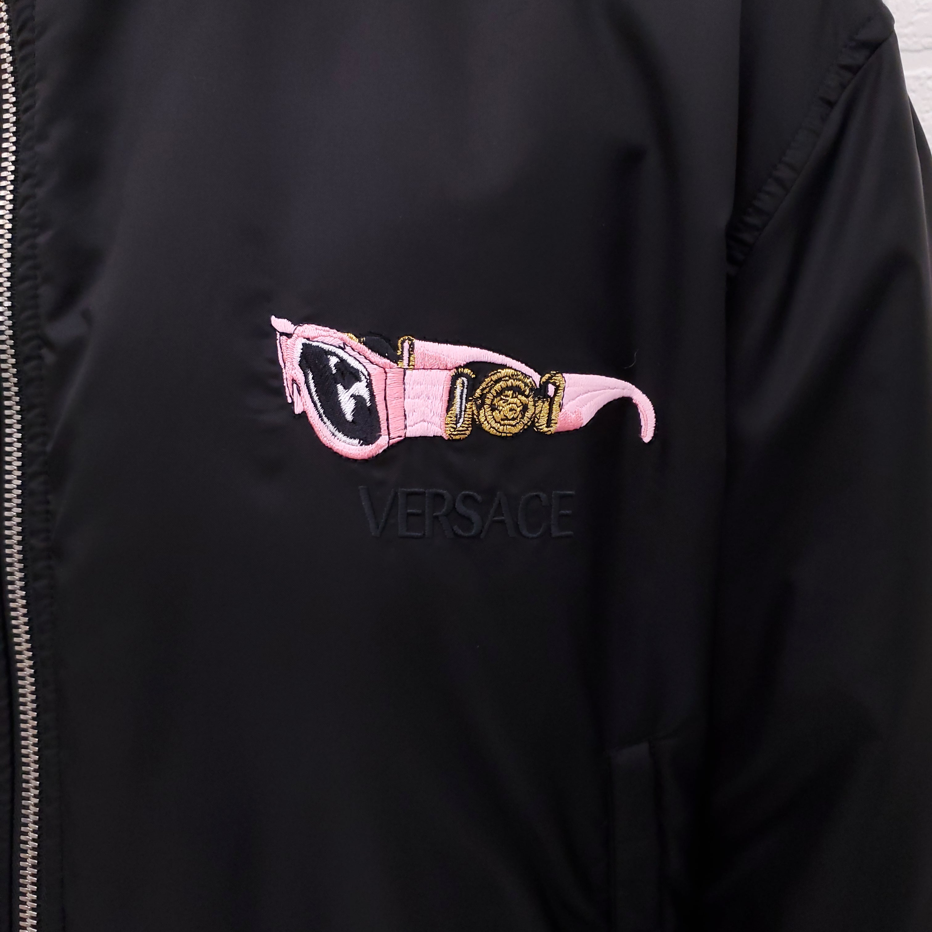 VERSACE BLACK REVERSIBLE BOMBER JACKET WITH SUNGLASSES DETAIL - SIZE 50