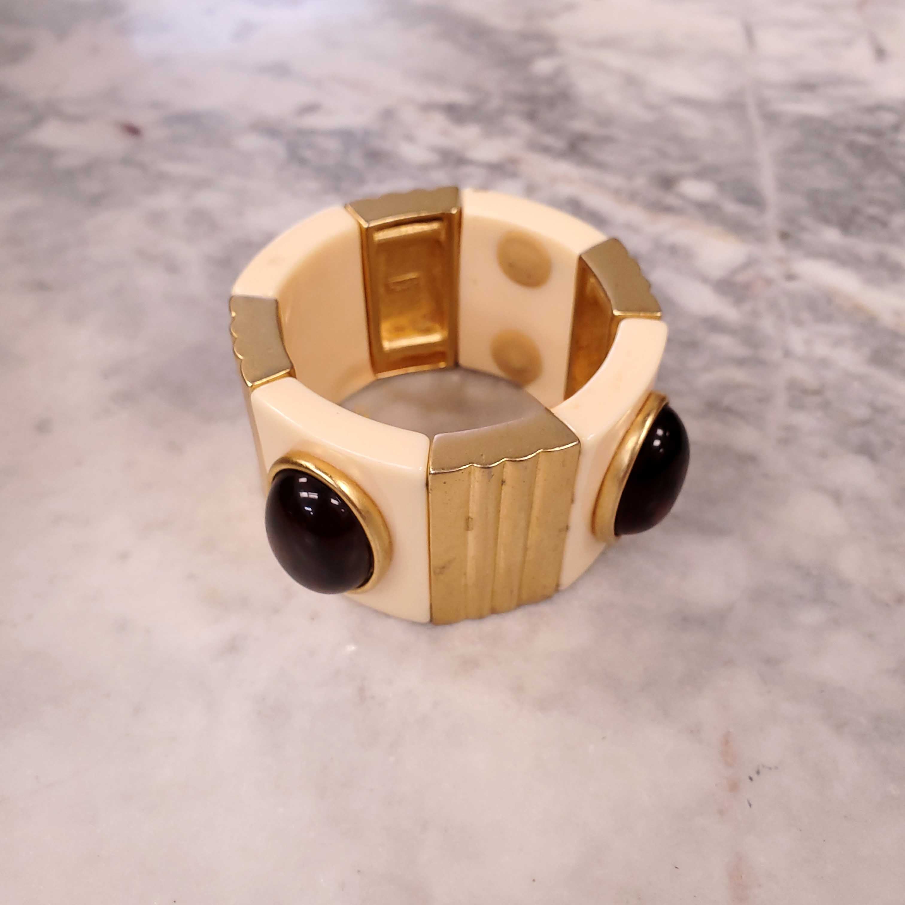 YVES SAINT LAURENT EXPANSION BRACELET WITH AMBER CABOCHONS SET IN CREAM AND GOLD-COLOURED PLASTIC