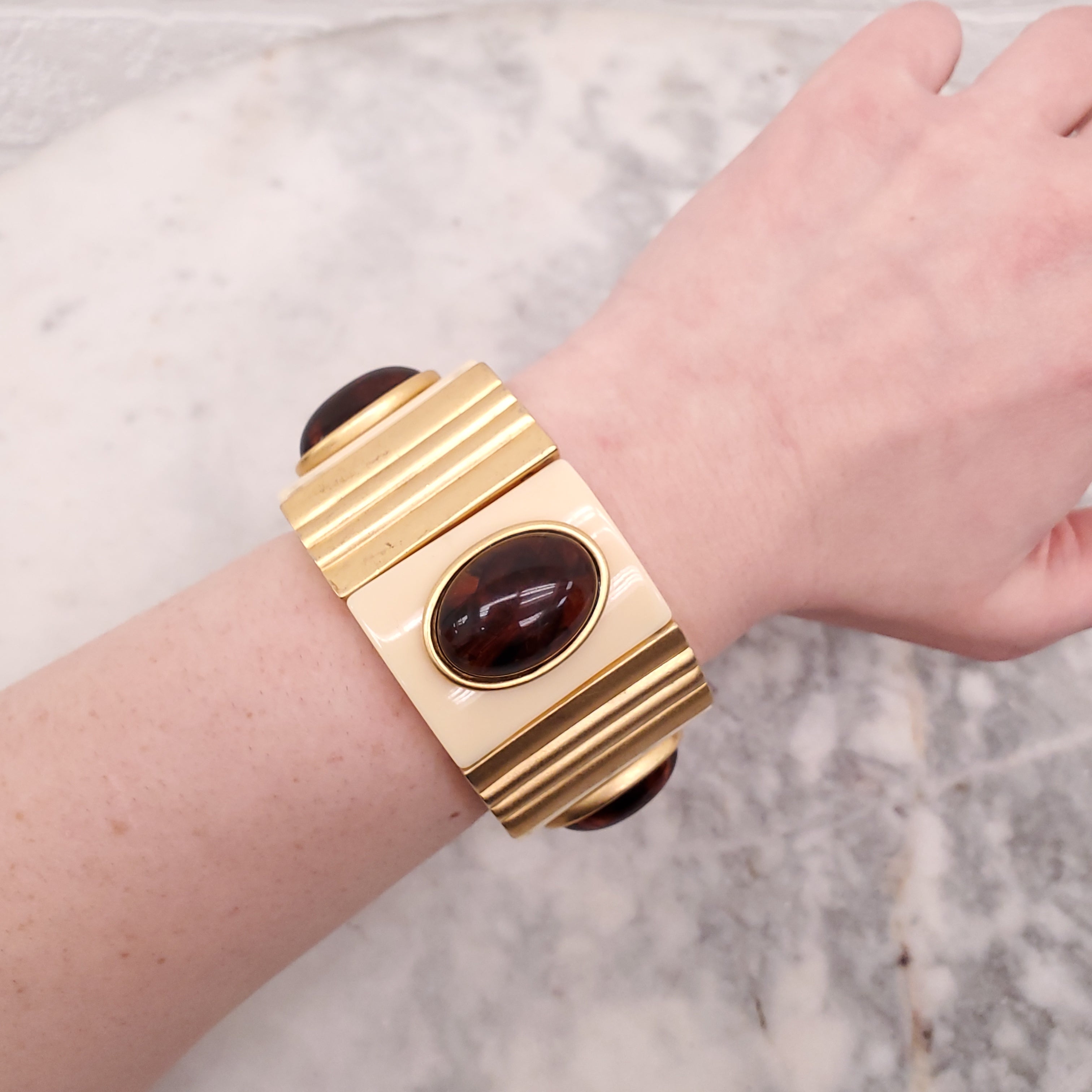 YVES SAINT LAURENT EXPANSION BRACELET WITH AMBER CABOCHONS SET IN CREAM AND GOLD-COLOURED PLASTIC